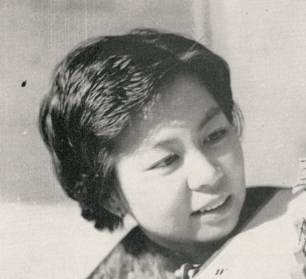 Man and woman examine a detailed architectural model of a house.