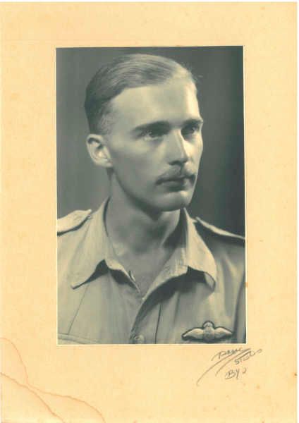 Black and white portrait of a man in a military uniform with a mustache.