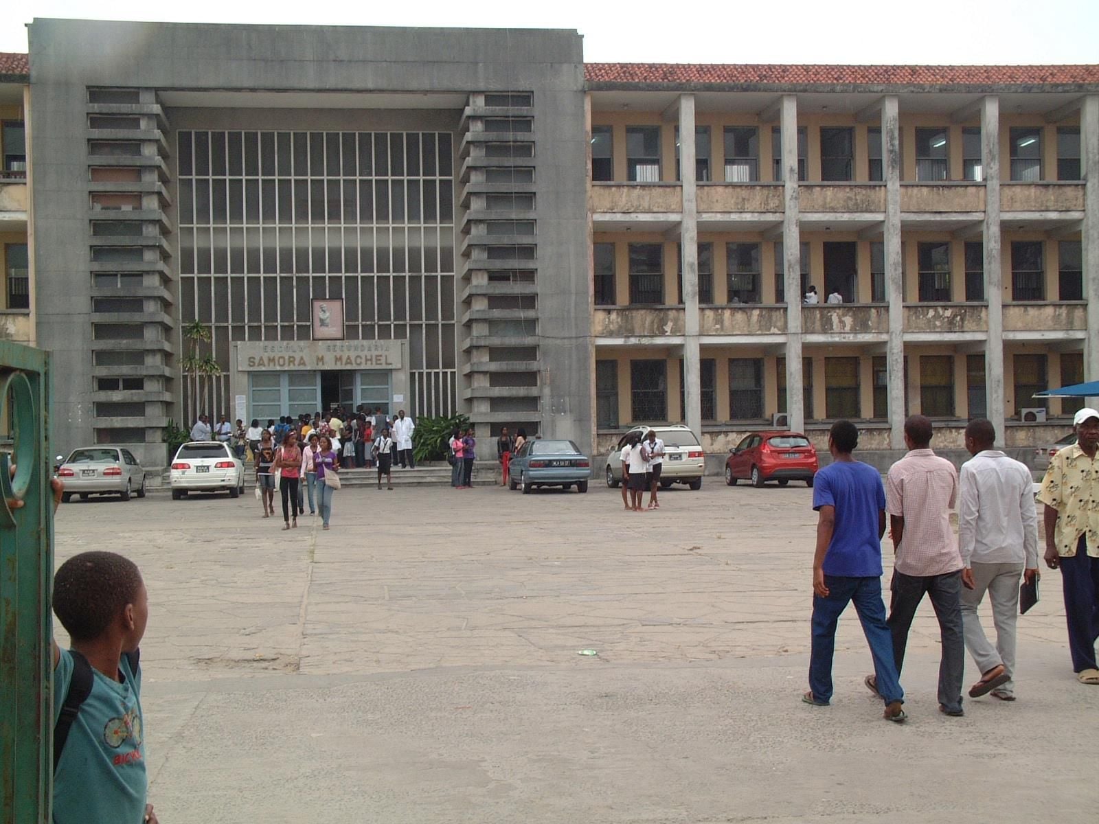 Large, imposing building with a symmetrical facade and multiple floors of windows.
