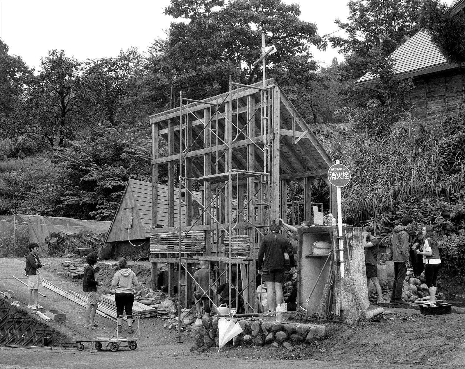 Black and white photograph of a wooden structure under construction