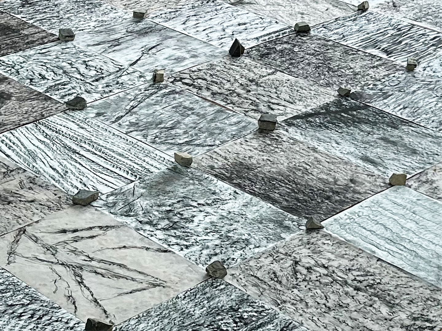 Photograph of tiled floor with stones